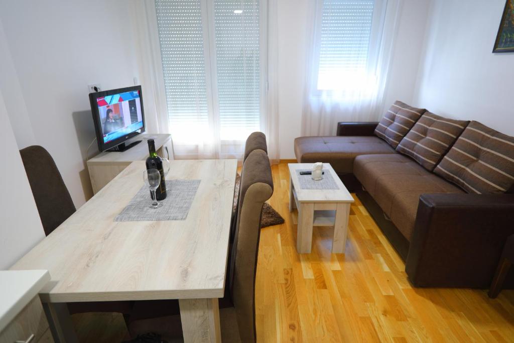 索科矿泉村Apartman Alegro的客厅配有桌子和沙发