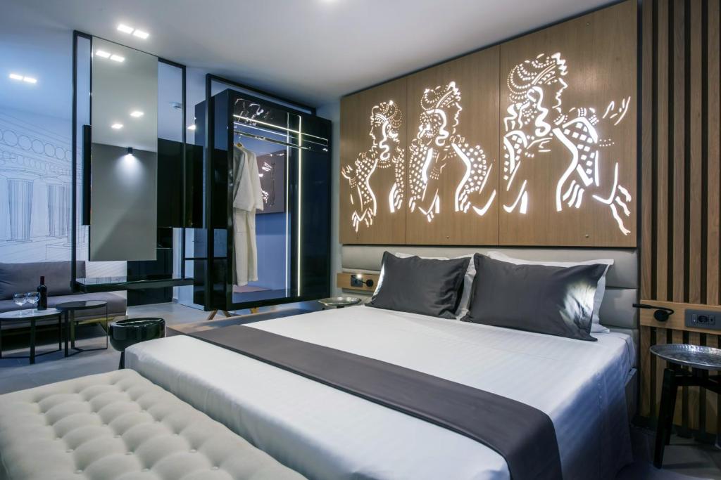 海若克利欧Lavris City Suites的卧室配有一张白色的大床和一张桌子