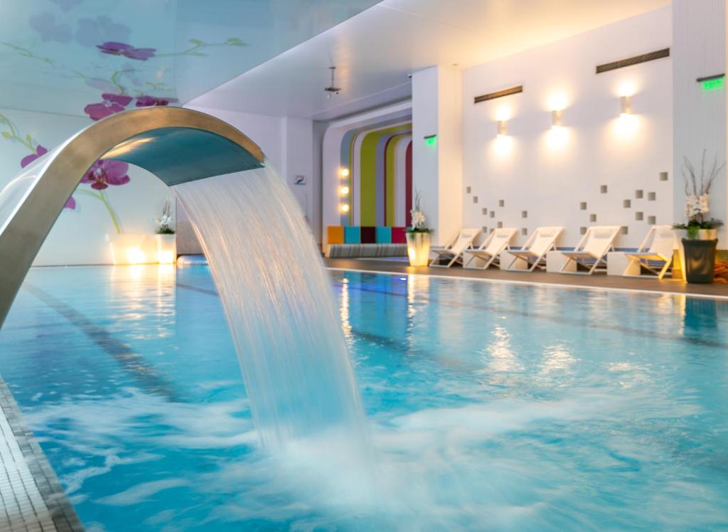 布加勒斯特奥赫第亚住宿及Spa的一座酒店带喷泉的游泳池
