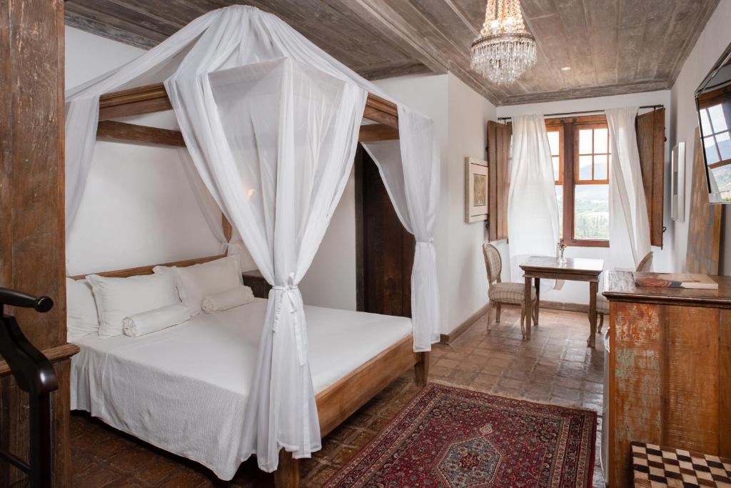 蒂拉登特斯Pouso da Torre的一间卧室配有一张带天蓬的床