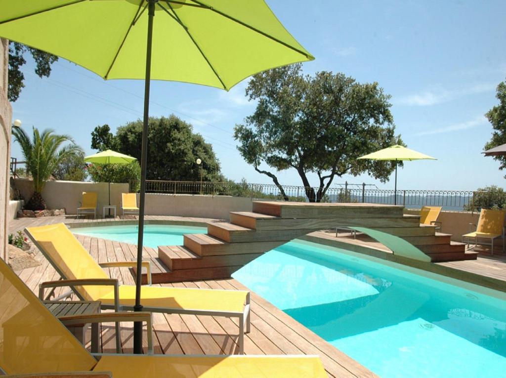 维琪奥港Bungalows Du Maquis的游泳池设有黄色椅子和遮阳伞