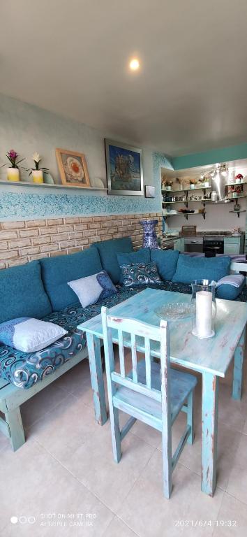 维拉Apartamento Belmonte 7的客厅配有蓝色的沙发和桌子