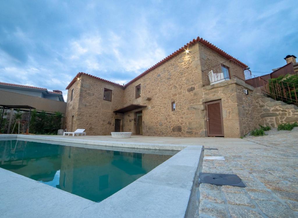 布拉加Villae Carreiro的一座别墅,在一座建筑前设有一个游泳池