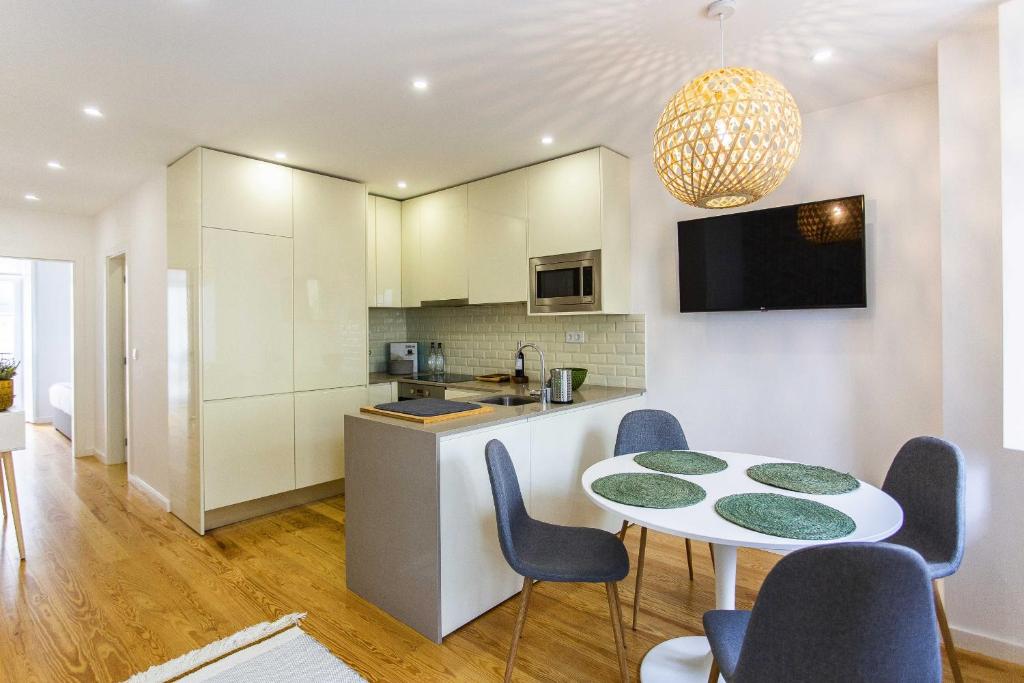 里斯本Prestige Ajuda Apartment的厨房以及带桌椅的用餐室。