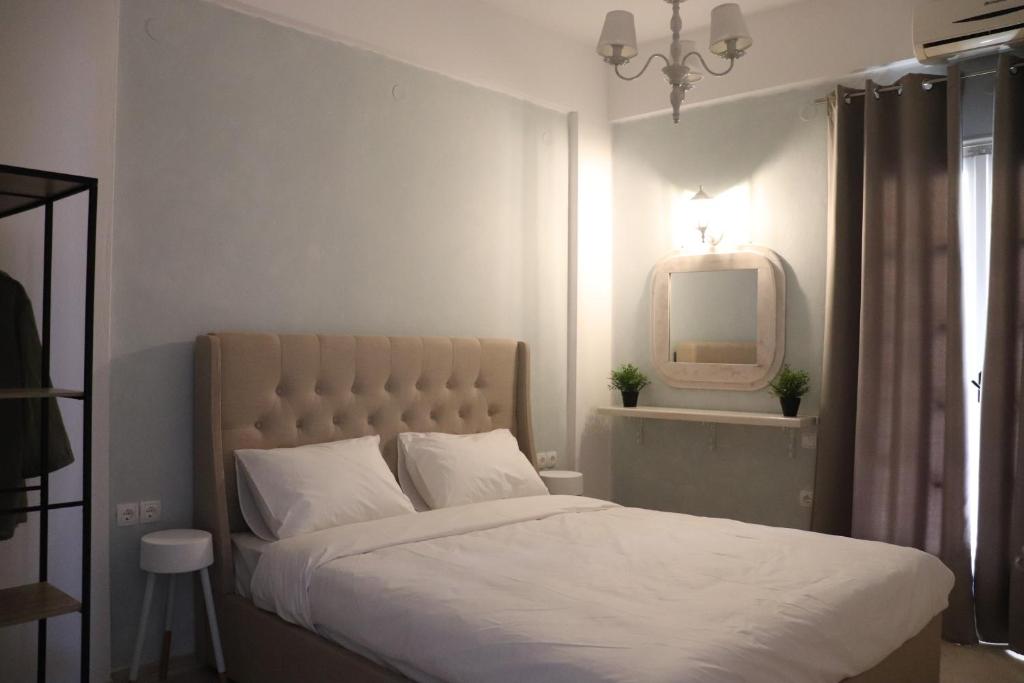 帕尔加Nerajoula House的卧室配有白色的床和镜子