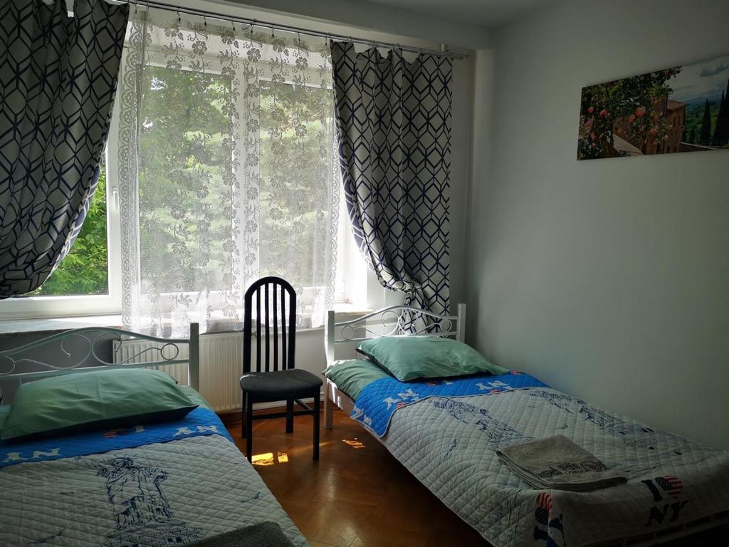 华沙Mira Rent House的一间卧室设有两张床和窗户。