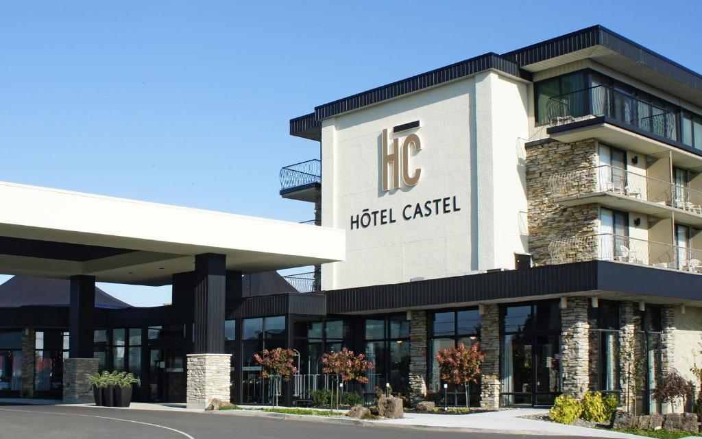 格兰比Hôtel Castel的上面有酒店卡片标志的酒店大楼