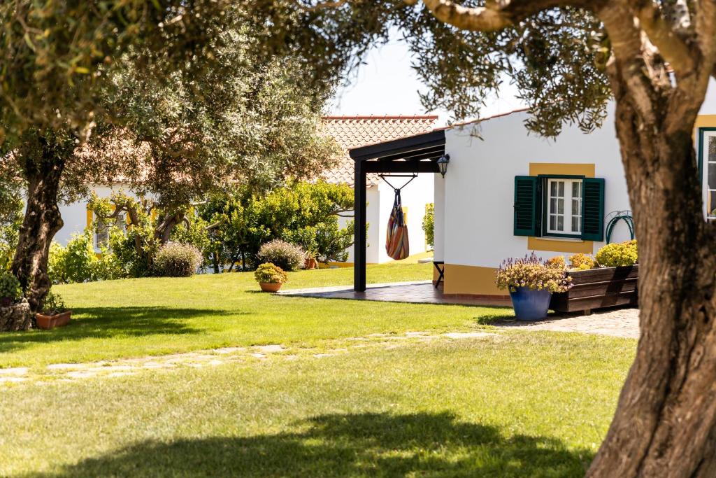 赞布热拉-杜马尔阿尔佩杜拉斯山酒店的花园,带绿色百叶窗的白色房子