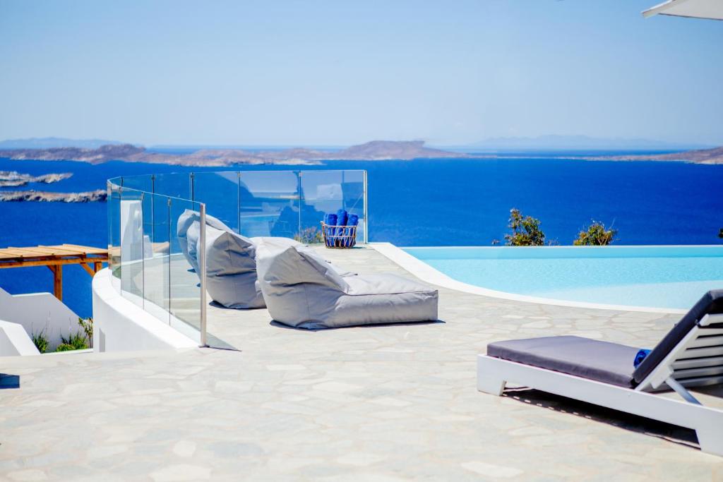 图罗斯阿迪西洛度假屋的一个带游泳池和椅子的临水天井