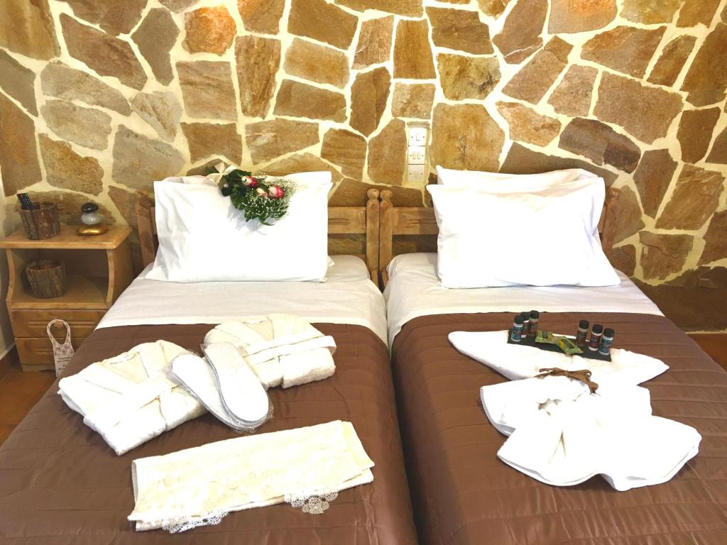 卢特拉艾季普苏Pansion Elli的一间卧室配有两张带毛巾和鞋子的床