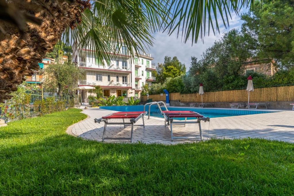阿拉西奥花园酒店的一个带2个长椅的游泳池和游乐场