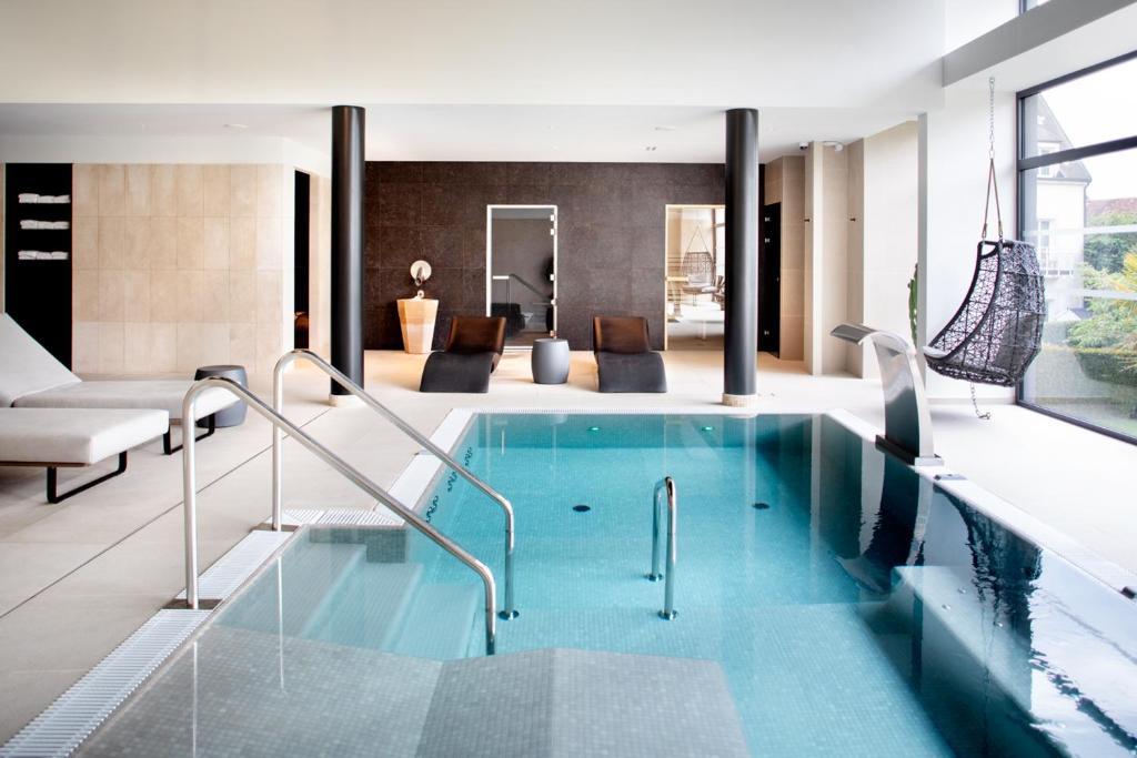 沃恩-罗曼尼乐利斯铂尔格酒店，餐厅及Spa中心的游泳池,位于带客厅的房屋内
