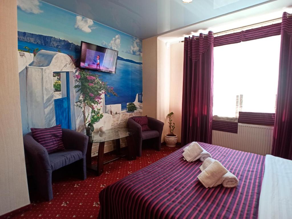 伊万诺-弗兰科夫斯克豪华公寓式酒店的一间卧室配有一张床,上面有两条毛巾
