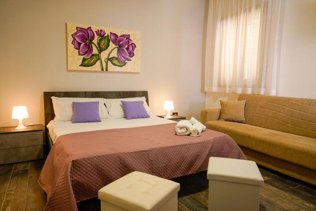 托雷拉皮罗LILLO Camere-Vacanze的一间卧室配有一张床和一张沙发