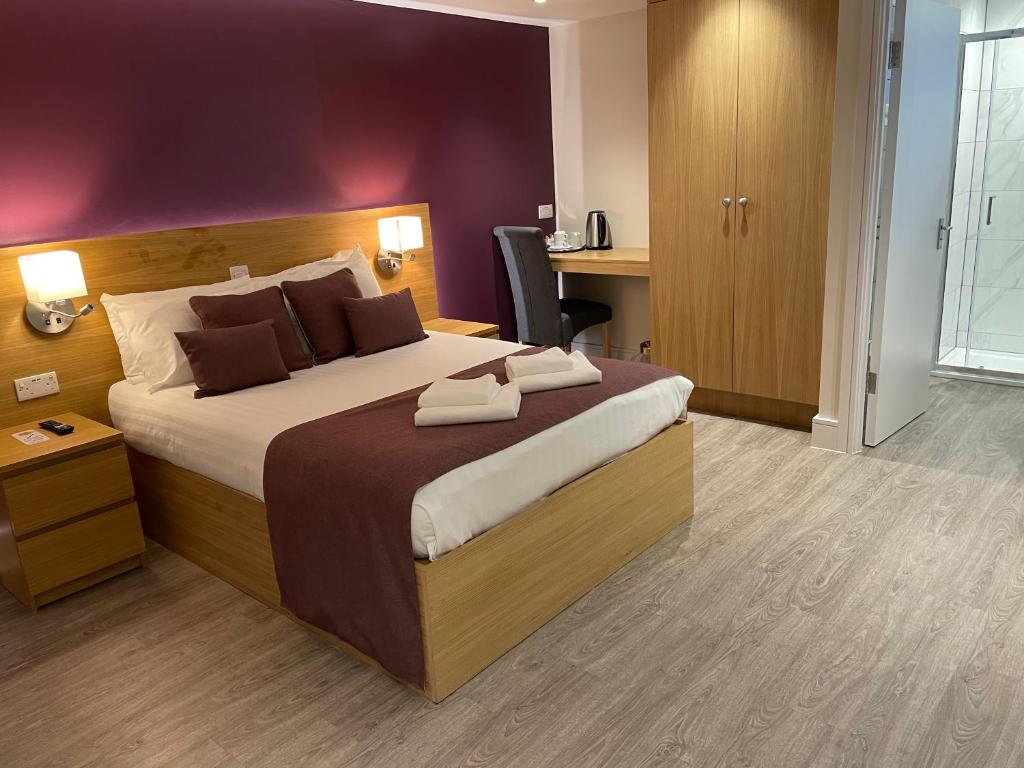 恩菲尔德霍尔特华特斯酒店的一间卧室配有一张大床和一张书桌