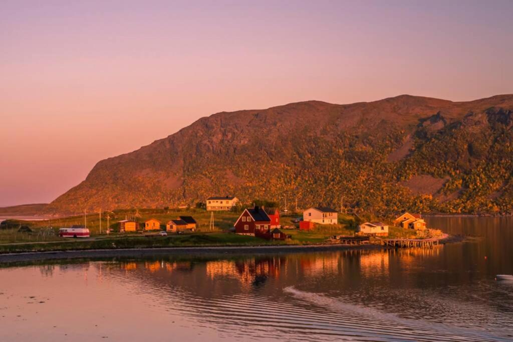 RussenesSmørfjord Ferieleilighet的水体岸边的一群房子