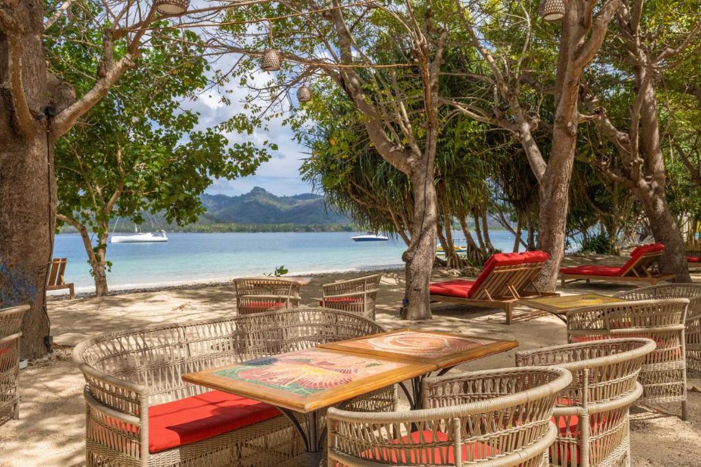 吉利阿萨汉Amahelia Luxury Resort & Restaurant - Gili Asahan的一张桌子和椅子,享有水景
