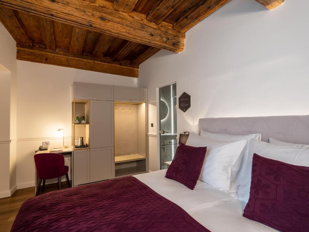 卢布尔雅那Hotel Heritage的一间卧室配有一张大床和一张书桌