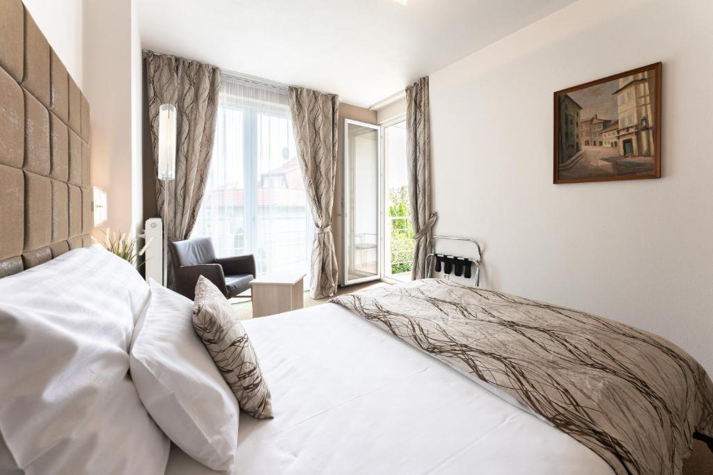布拉迪斯拉发安塔芮丝酒店的卧室配有白色的床和窗户。