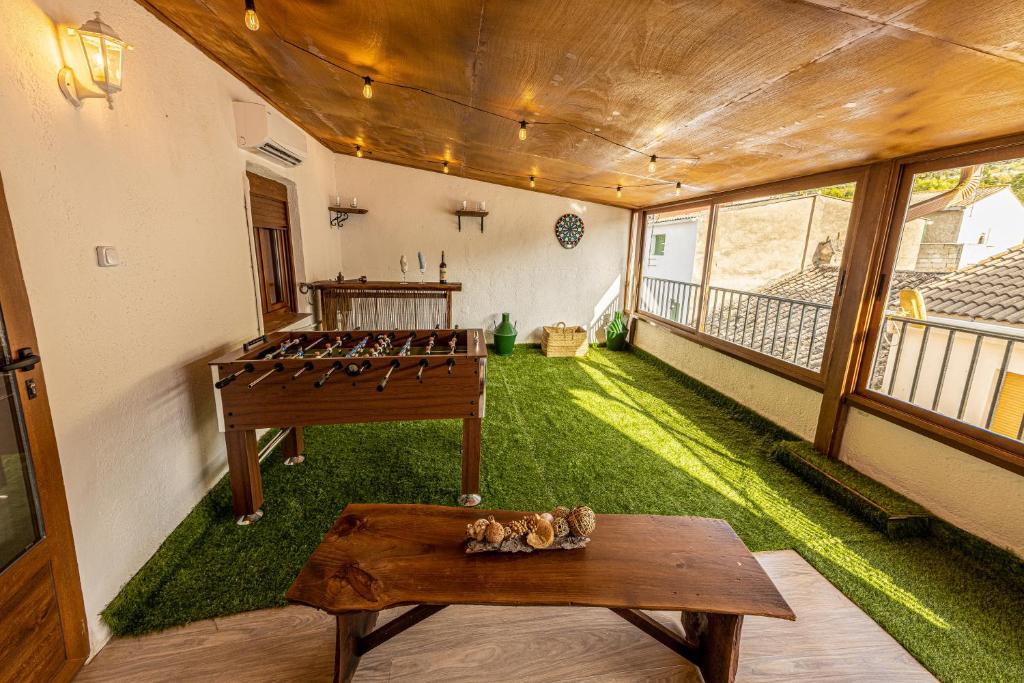 ArbunielCasa El Forestal的一间设有绿地和桌子的房间