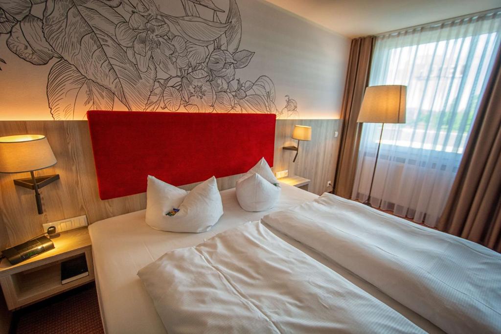爱尔福特厄弗特-阿普费尔斯特贝斯特韦斯特酒店的卧室配有一张带两个枕头的大白色床