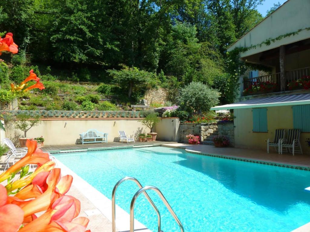卡斯特尔Mille Fleurs a romantic enchanting renovated luxury Bastide with shared pool的一座房子旁的院子内的游泳池