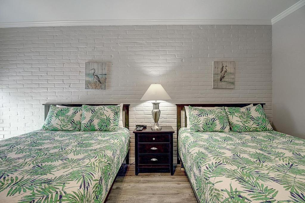 阿兰瑟斯港Channelview 108的一间卧室配有两张床和床头灯。