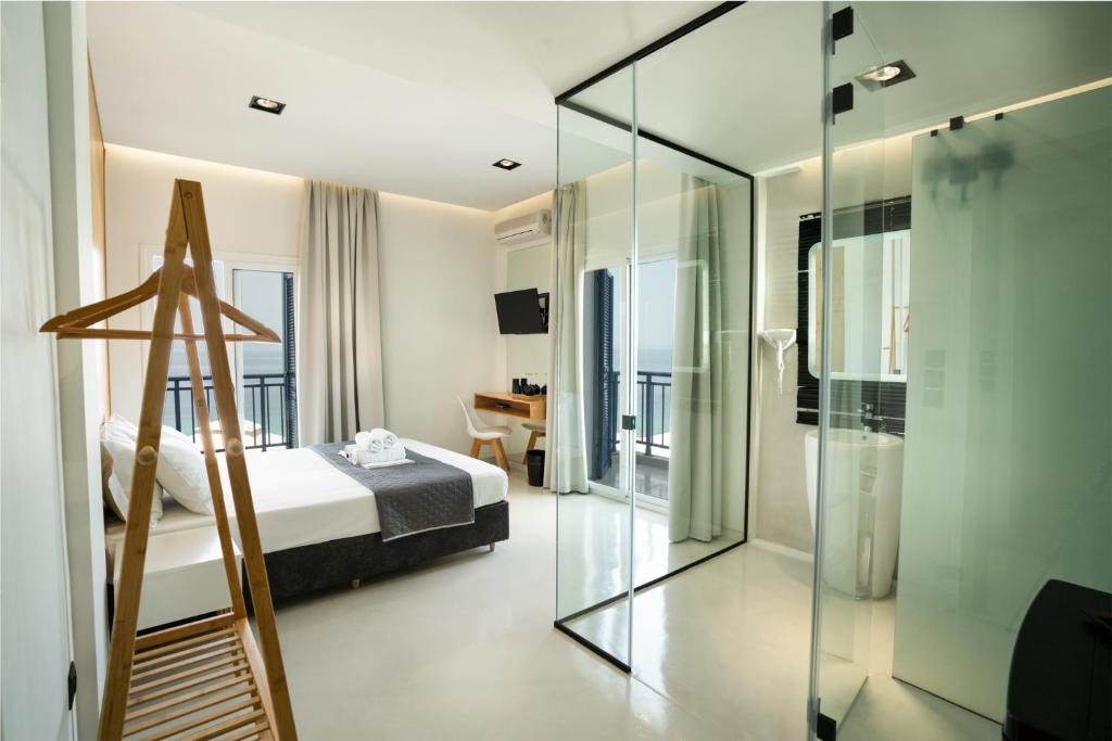 阿菲托斯Vrachos Lofts的一间卧室设有一张床和玻璃墙
