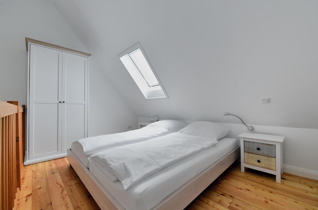 滕宁Lille Solskin的白色的卧室设有床和窗户