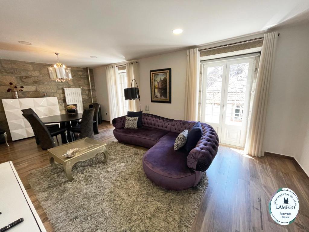 拉梅戈Apartamento da Seara "Lamego"的客厅配有紫色沙发和桌子