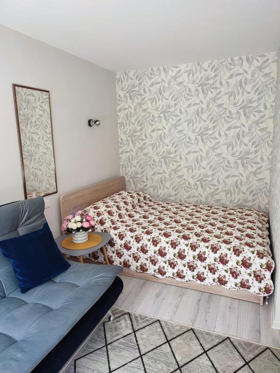 比尔扎伊Upės apartamentai的一间小卧室,配有一张床和一张桌子