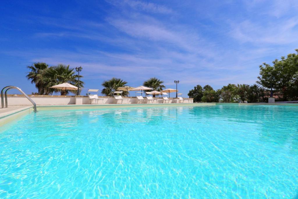 佩斯科勒海滨Tenuta Li Fani Residence Hotel的蓝色海水大型游泳池