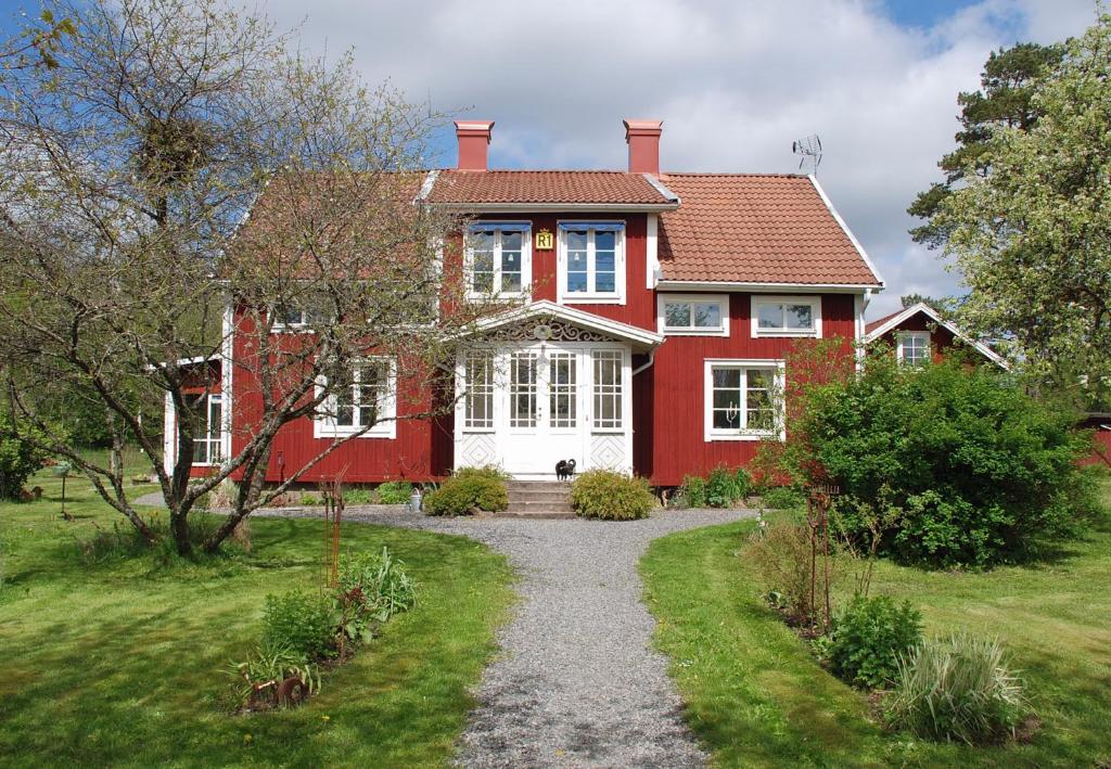 斯切灵加德Villa Vilan - Countryside Lodging的一座红色和白色的房子,有碎石车道