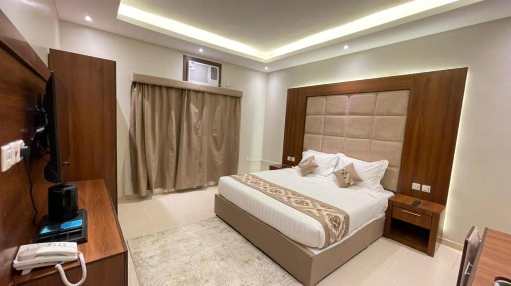 麦地那Rawaes Hotel的酒店客房设有床、电话和电视。