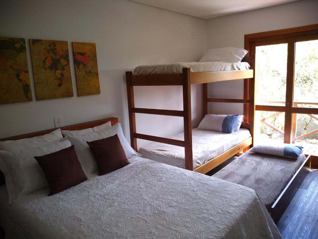 卡内拉Residencial Franzen的一间卧室设有两张双层床和一扇窗户。