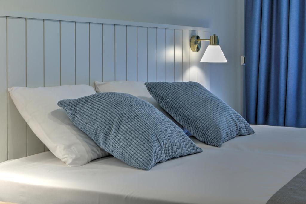 尤尔马拉Marine Hotel Jūrmala的床上有2个枕头
