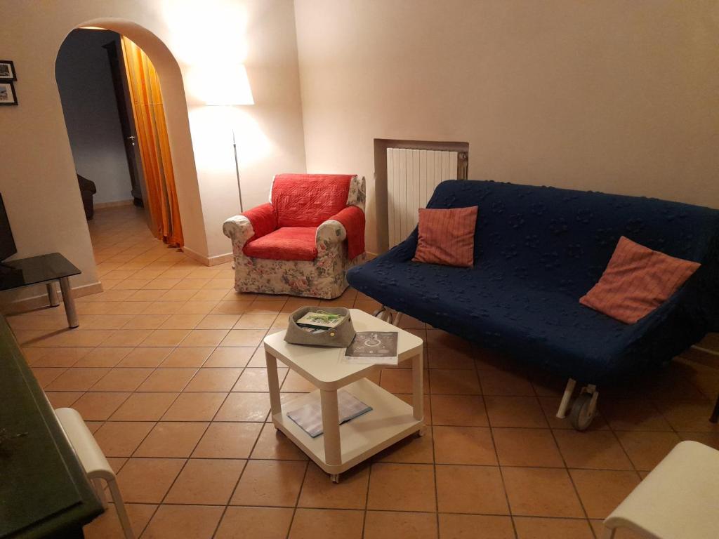 科森扎Casa Elisa的客厅配有蓝色的沙发和红色的椅子