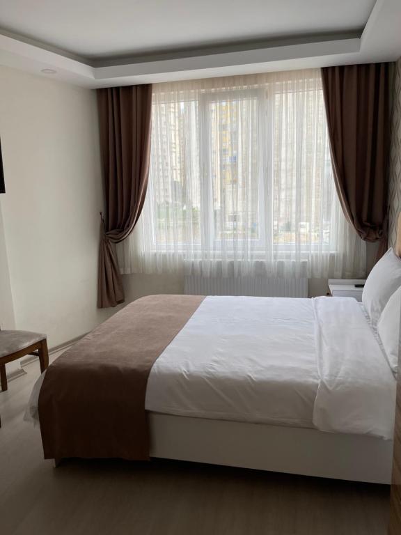 伯萨Bursa Malkoc Hotel的一间卧室设有一张大床和一个窗户。