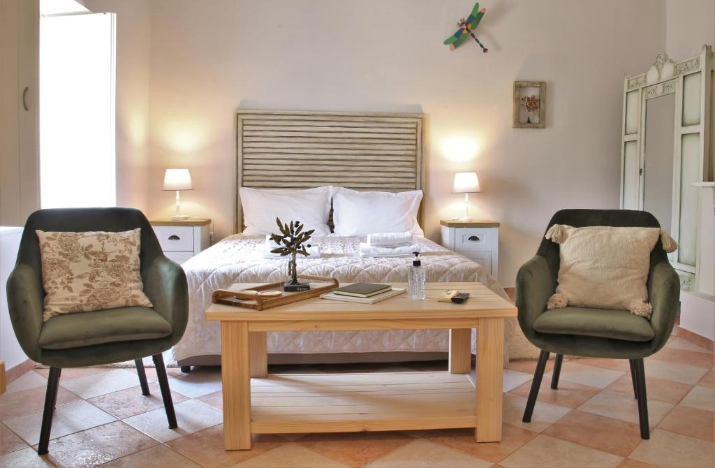 斯巴达For4 Seasons Home 2 - by Avelink的一间卧室配有一张床、两把椅子和一张桌子