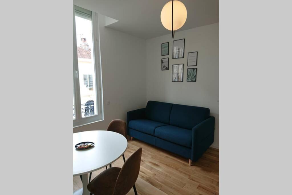 波尔多appartement 4 pers quartier Chartrons à Bordeaux的客厅配有蓝色的沙发和桌子