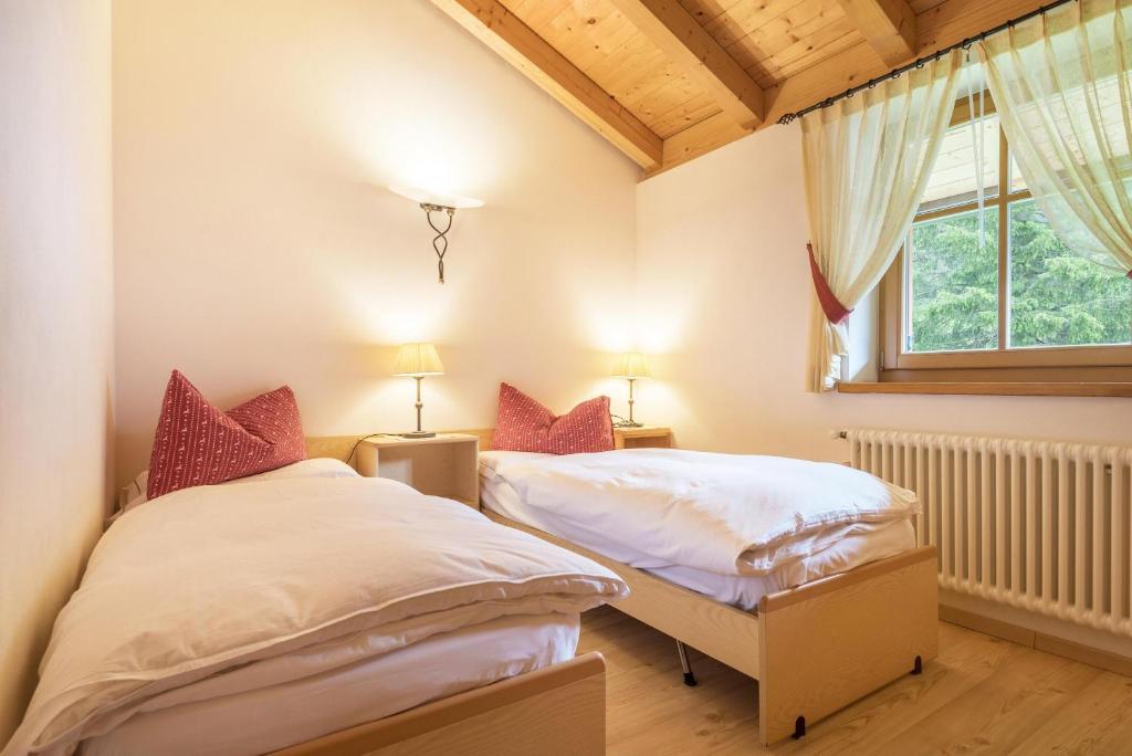 卡纳泽伊Chalet Crepes De Sela的带窗户的客房内设有两张单人床。
