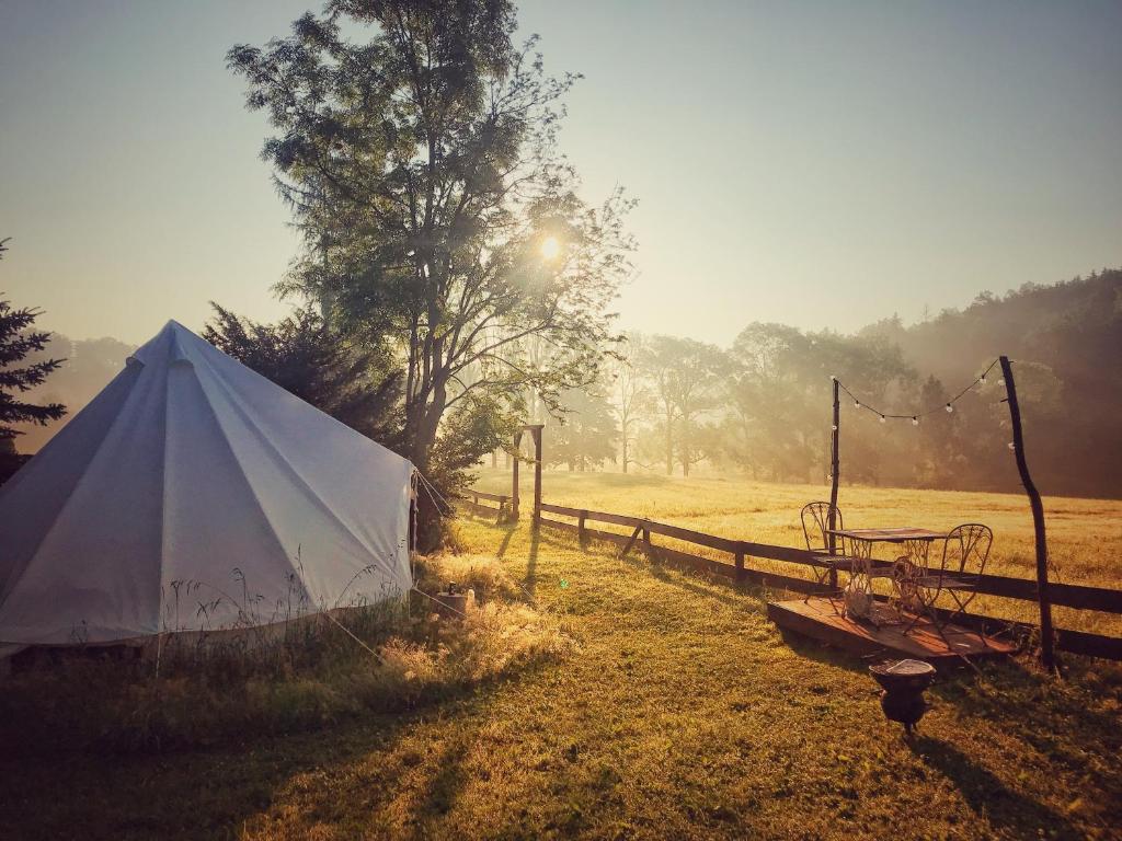RůžováTrapani glamping camp的围栏旁田野上的白色帐篷