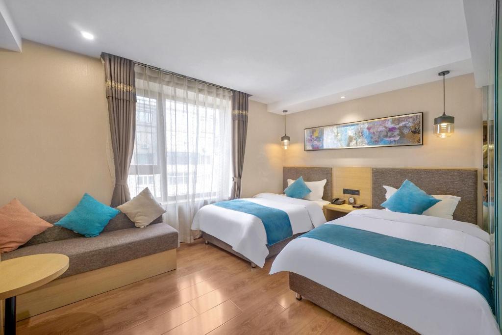 哈尔滨哈尔滨旅悦精品酒店的酒店客房,设有两张床和一张沙发