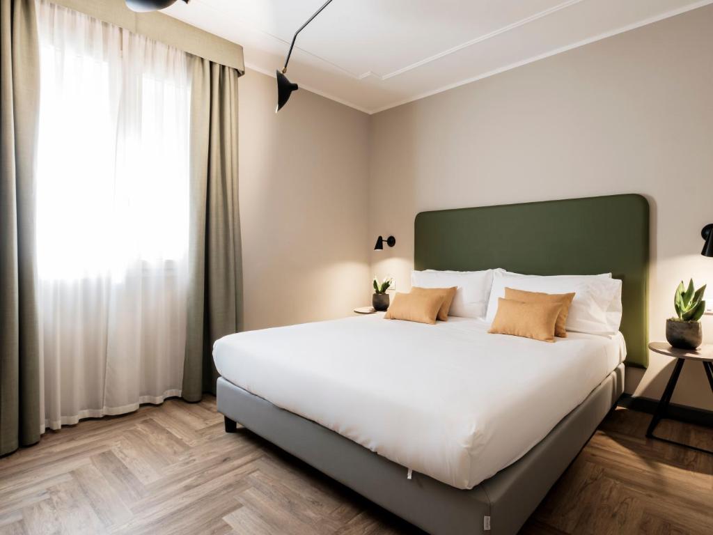 弗利洛里酒店 的卧室设有一张白色大床和一扇窗户。