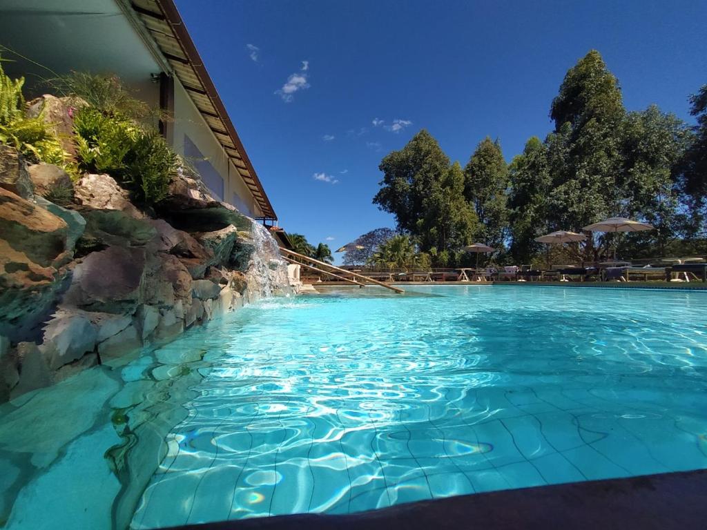 雅博蒂卡图巴斯Village Resort的度假村内的一个蓝色海水游泳池