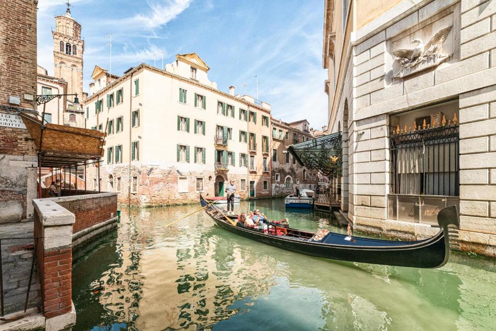 威尼斯Casanova Fenice - Canal View的一群人沿着运河乘坐缆车
