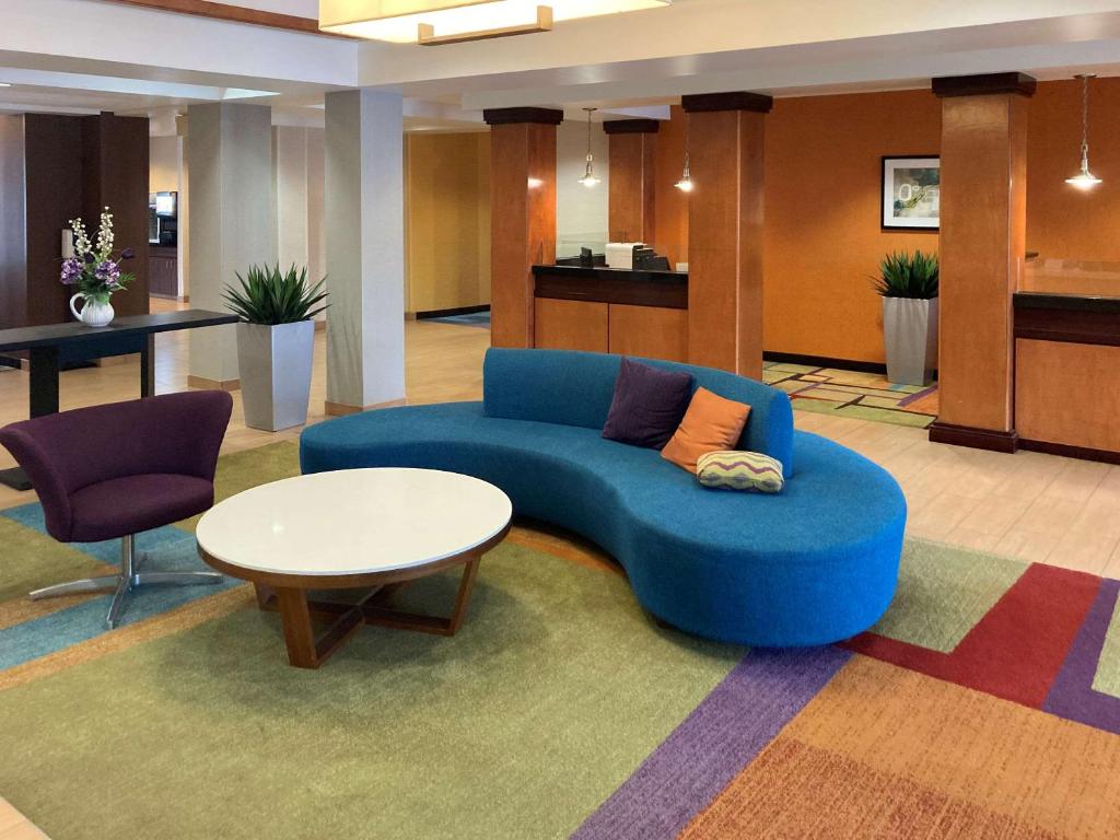 安克尼Comfort Inn & Suites Ankeny - Des Moines的客厅配有蓝色的沙发和桌子