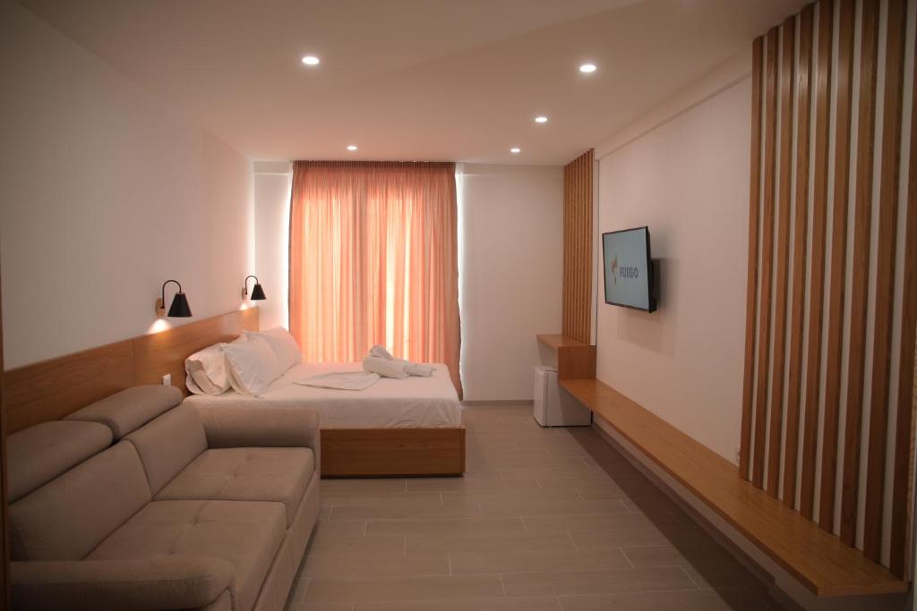 莱什Serenity In的一间卧室配有一张床、一张沙发和一台电视