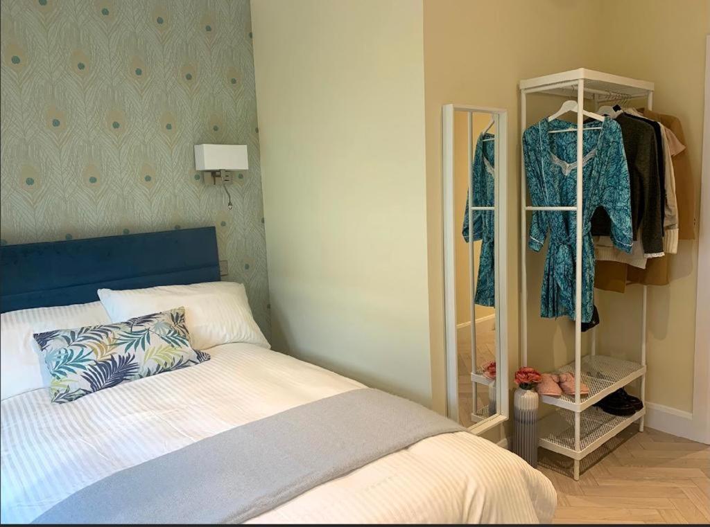基尔肯尼Apartment, Kilkenny City的一间卧室配有一张床和一个衣柜,内配衣服