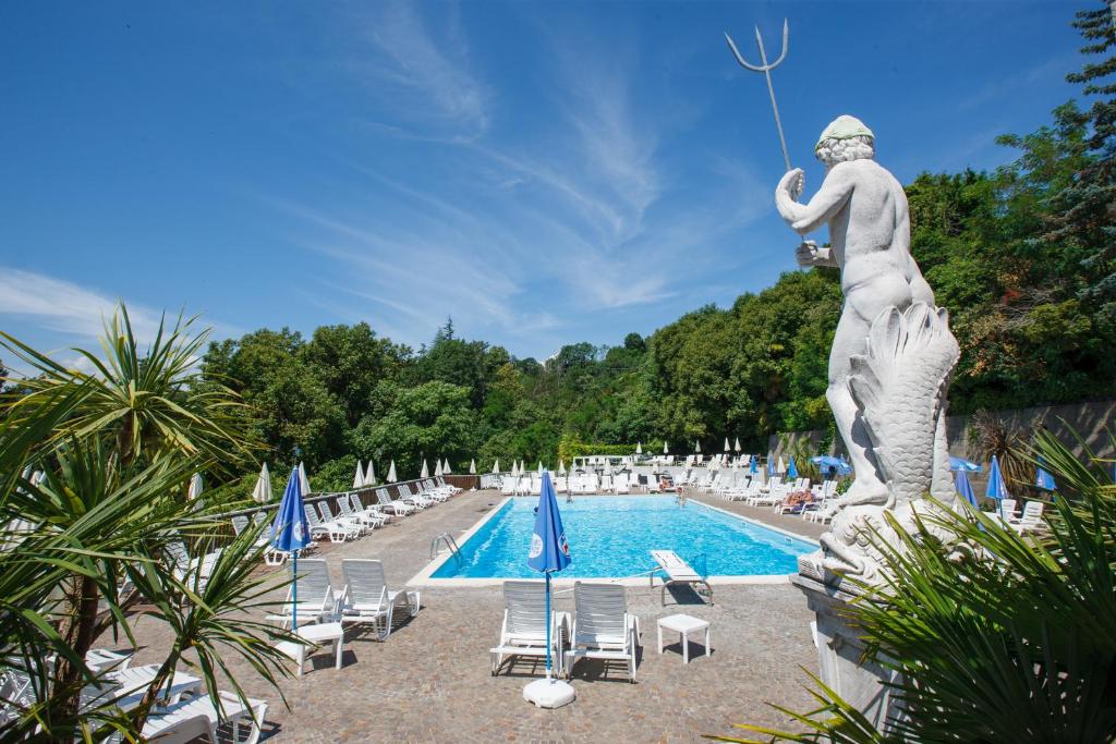 吉法Residenz La Selva的站在游泳池旁的女人的雕像